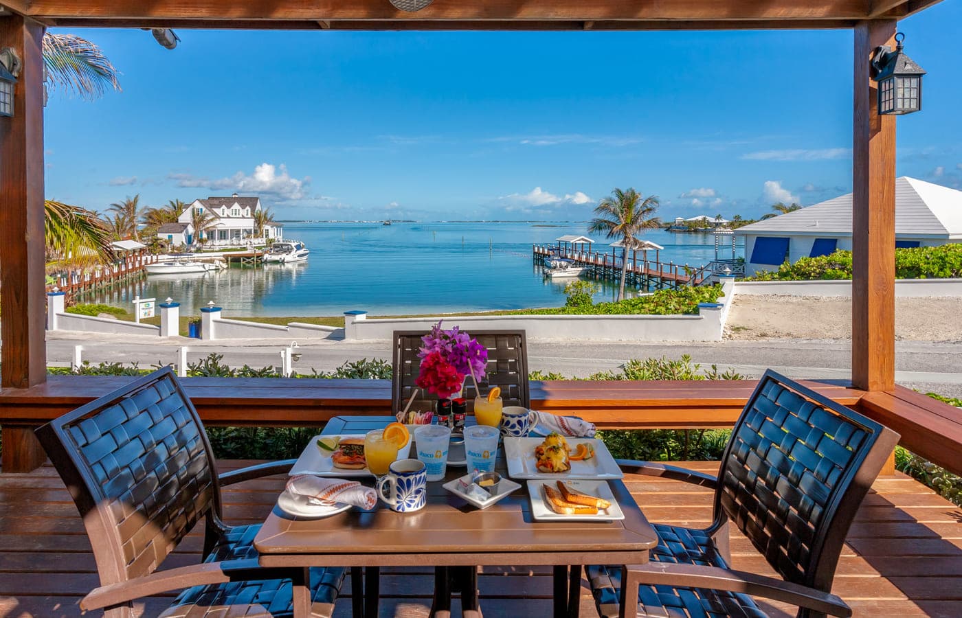 A table framed by the pergola, harbour beyond