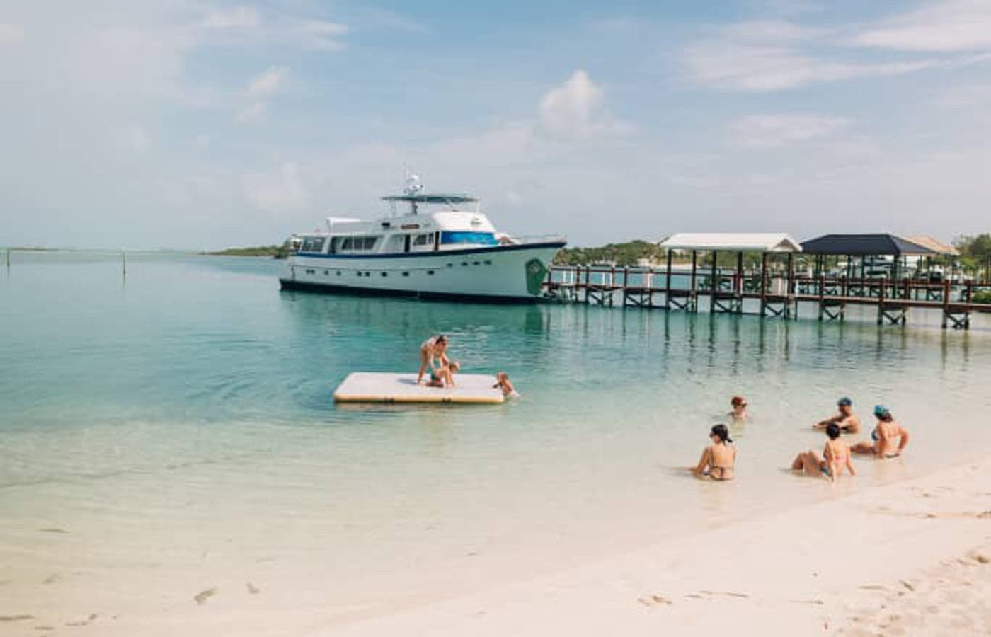 A boat at the pier in shallow turquoise water