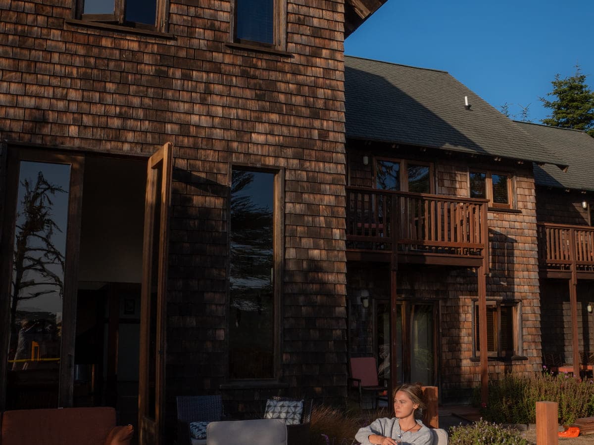 The redwood-shingled exterior of Brewery Gulch Inn at golden hour