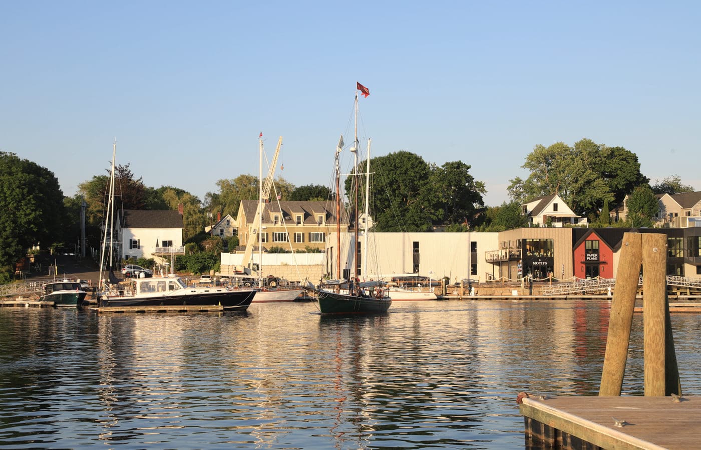 Schooners moored in Camden harbour in low evening light