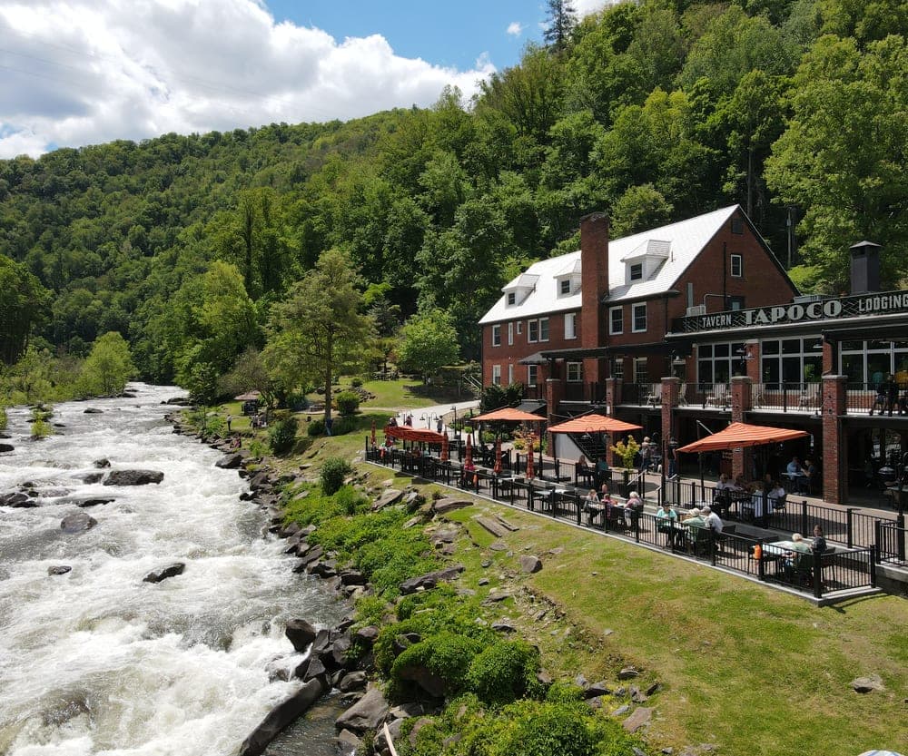 Guests dining on the riverside terrace above the Cheoah