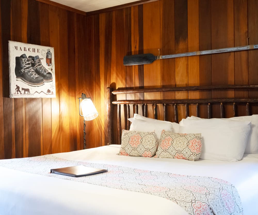 Wood-panelled guest room in the main lodge